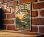 A vintage metal sign for Brazos Bend State Park in Texas, featuring an illustration of a crocodile in a pond with a sunset in the background.