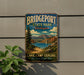 A vintage metal sign for Bridgeport State Park in Washington, featuring a scenic landscape with a lake, mountains, and a bridge.