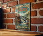 A vintage-style metal sign for Brownstone Falls State Park in Wisconsin, featuring a scenic image of the waterfall surrounded by trees and rocks.
