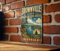 A vintage-style metal sign for the Brownville State Recreation Area in Nebraska, featuring a scenic landscape with a river and mountains.