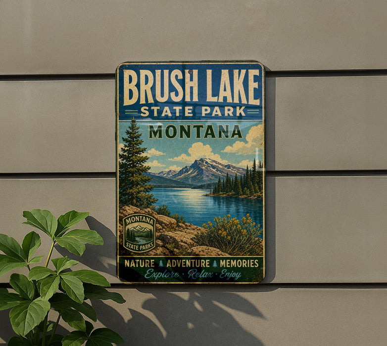 A vintage-style metal sign for Brush Lake State Park in Montana, featuring a scenic landscape with mountains, trees, and a lake.