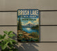 A vintage-style metal sign for Brush Lake State Park in Montana, featuring a scenic landscape with mountains, trees, and a lake.