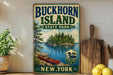 A vintage-style sign for Buckhorn Island State Park in New York, featuring a scenic image of a lake, island, and canoe.
