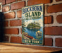 A vintage-style metal sign for Buckhorn Island State Park in New York, featuring a scenic illustration of a lake, island, and canoe.