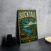 A vintage metal sign for Bucktail State Park in Pennsylvania, featuring a scenic landscape with a lake and mountains.