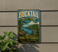 A metal sign with the text "BUCKTAIL STATE PARK PENNSYLVANIA" and a scenic illustration of a lake surrounded by mountains and pine trees.