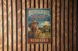 A vintage-style metal sign for Buffalo Bill Ranch, a historic park in Nebraska, featuring an illustration of a man in a cowboy hat and a building in the background.