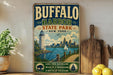 A vintage-style sign for Buffalo Harbor State Park, featuring a lighthouse, a city skyline, and a body of water with a sailboat.