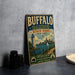 A vintage-style metal sign for Buffalo Harbor State Park, featuring a lighthouse and a city skyline, is displayed on a gray concrete surface.