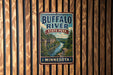 A vintage metal sign for Buffalo River State Park in Minnesota, featuring a scenic illustration of the river surrounded by lush green forests.
