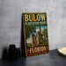 A vintage-style metal sign for Bulow Plantation Ruins, a historic state park in Florida, featuring an illustration of the ruins and palm trees.