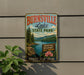 A vintage-style metal sign for Burnsville Lake State Park, featuring a scenic landscape with pine trees, a lake, and mountains.