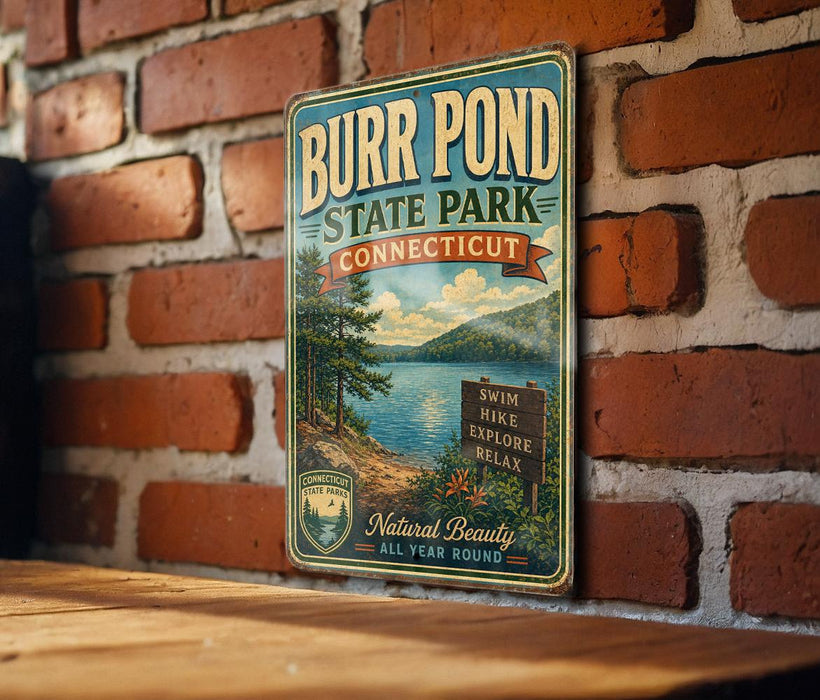 A vintage metal sign for Burr Pond State Park in Connecticut, featuring a scenic landscape with a lake and mountains.