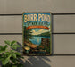 A vintage-style metal sign for Burr Pond State Park in Connecticut, featuring a scenic landscape with a lake and mountains.