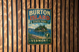 A vintage metal sign for Burton Island State Park in Vermont, featuring a scenic illustration of the island and its surroundings.