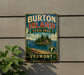 A vintage metal sign for Burton Island State Park in Vermont, featuring a scenic illustration of the island and its surroundings.