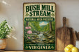 A vintage-style sign for Bush Mill Stream National Area Preserve in Virginia, featuring a scenic image of a stream surrounded by trees and flowers.