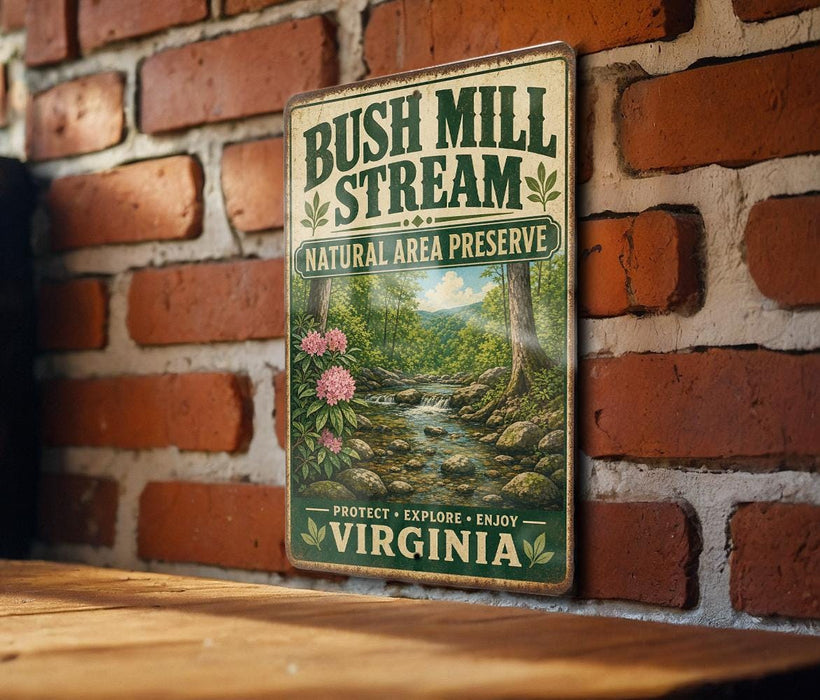 A vintage-style metal sign for Bush Mill Stream National Area Preserve in Virginia, featuring a scenic image of a stream surrounded by trees and flowers.