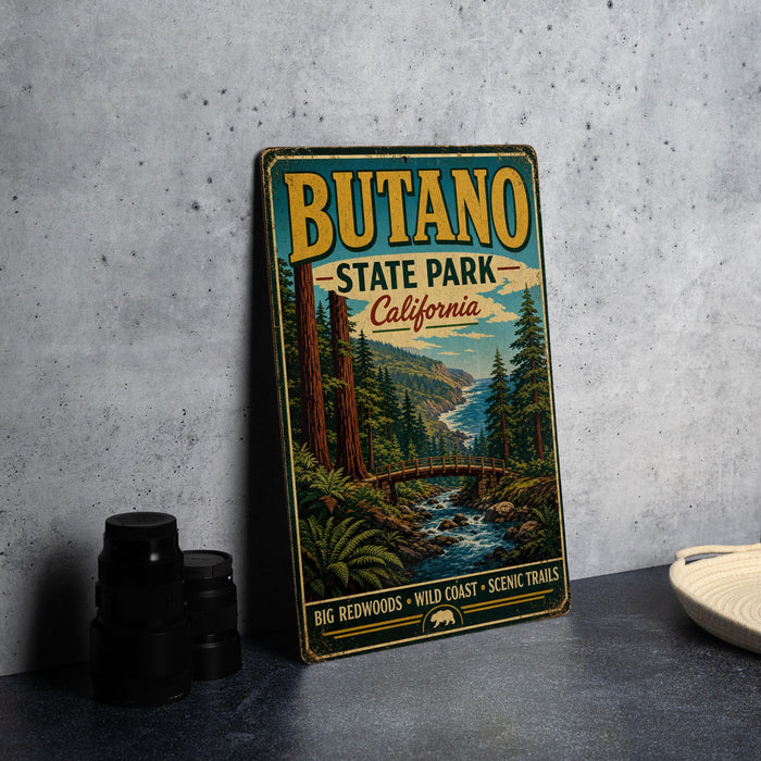 A vintage-style metal sign for Butano State Park, California, featuring a scenic illustration of the park's landscape.