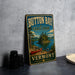 A vintage-style metal sign for Button Bay State Park in Vermont, featuring a scenic image of a lake, canoe, and mountains.