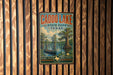 A vintage metal sign for Caddo Lake State Park in Texas, featuring a scenic illustration of a boat on the lake and a cypress tree.