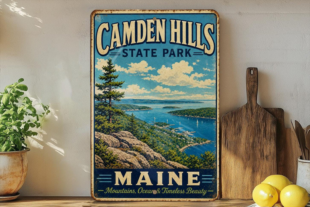 A vintage-style metal sign for Camden Hills State Park in Maine, featuring a scenic landscape with mountains, ocean, and a lake.