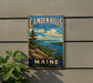 A vintage metal sign for Camden Hills State Park in Maine, featuring a scenic landscape with mountains, water, and a pine tree.