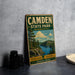 A vintage metal sign for Camden State Park in Minnesota, featuring a scenic landscape with a lake and mountains.