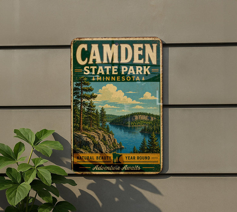 A vintage metal sign for Camden State Park in Minnesota, featuring a scenic landscape with pine trees, a lake, and mountains.