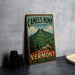 A vintage metal sign for Camels Hump State Park, featuring a mountain landscape and the words "Beautiful Vermont" in a vintage style.