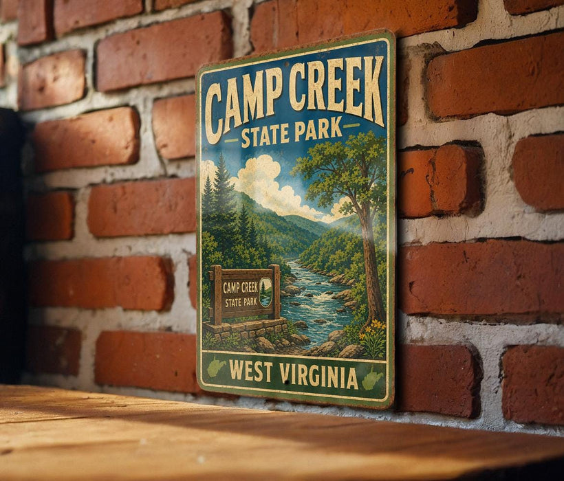 A vintage-style metal sign for Camp Creek State Park in West Virginia, featuring a scenic illustration of a river and forest landscape.