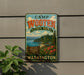A vintage-style metal sign for Camp Wooten State Park in Washington, featuring a scenic landscape with a mountain, pine trees, and a lake.