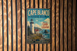 A vintage metal sign for Cape Blanco State Park in Oregon, featuring a lighthouse and coastal scenery.