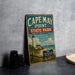 A vintage-style sign for Cape May Point State Park in New Jersey, featuring a lighthouse and beach scene.