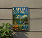 A vintage metal sign for Capital Springs State Recreation Area in Wisconsin, featuring a scenic illustration of the state's outdoor activities such as paddle, hike, and explore.