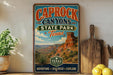 A vintage-style sign for Caprock Canyon State Park in Texas, featuring a desert landscape with a rock formation and a pine tree.