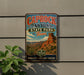 A vintage metal sign for Caprock Canyon State Park in Texas, featuring a desert landscape with a prominent rock formation.