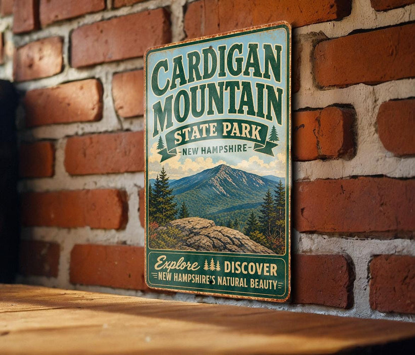 A vintage metal sign for Cardigan Mountain State Park, featuring a scenic mountain landscape and the text "Explore New Hampshire's Natural Beauty".