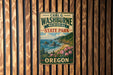 A vintage-style metal sign for Carl G. Washburne Memorial State Park in Oregon, featuring a scenic landscape with mountains, forests, and a body of water.