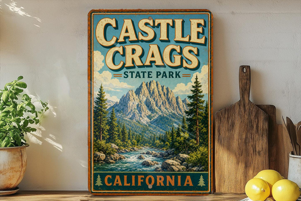 A vintage-style metal sign for Castle Crags State Park in California, featuring a scenic mountain landscape with a river and pine trees.
