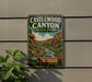 A vintage-style metal sign for Castlewood Canyon State Park, featuring a scenic illustration of the canyon landscape.