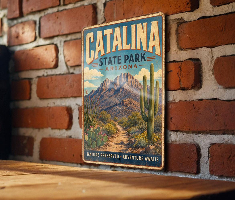A vintage-style metal sign for Catalina State Park in Arizona, featuring a desert landscape with mountains, cacti, and a trail.