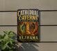 A vintage metal sign for Cathedral Caves State Park in Alabama, featuring an illustration of the cave system.