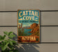 A vintage metal sign for Cattail Cove State Park in Arizona, featuring a desert landscape with mountains, cacti, and a body of water.