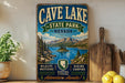 a vintage-style sign for Cave Lake State Park, Nevada, with a scenic mountain landscape and a lake in the background.