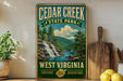A vintage-style sign for Cedar Creek State Park in West Virginia, featuring a scenic illustration of a waterfall surrounded by lush greenery.