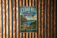A vintage metal sign for Cedar Hill State Park in Texas, featuring a scenic landscape with a lake, mountains, and cacti.