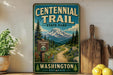 a vintage-style sign for Centennial Trail State Park in Washington, with a mountain landscape and trail sign.