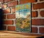 A vintage-style metal sign for Cerrillos Hills State Park in New Mexico, featuring a scenic landscape with mountains, desert vegetation, and a trail.
