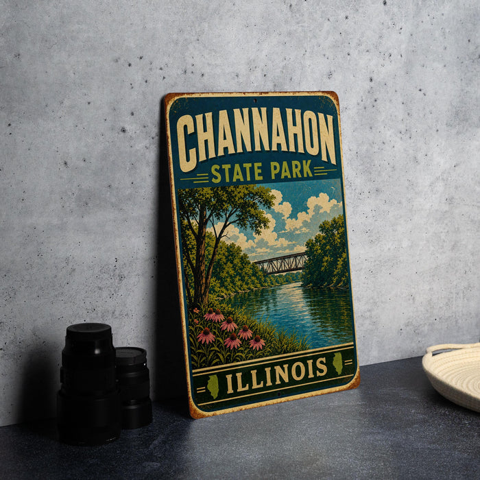A vintage-style metal sign for Channahon State Park in Illinois, featuring a scenic landscape with a river, bridge, and trees.